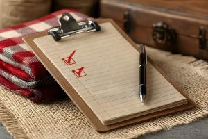 Checklist and Pen on Rustic Burlap Background